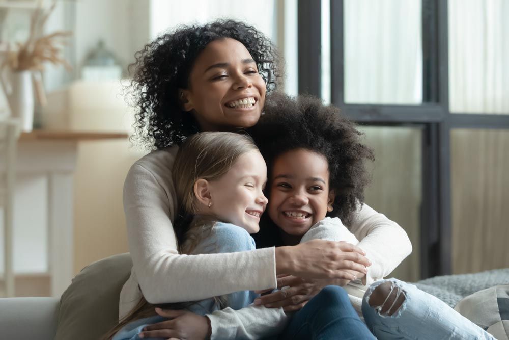 Lady hugging children